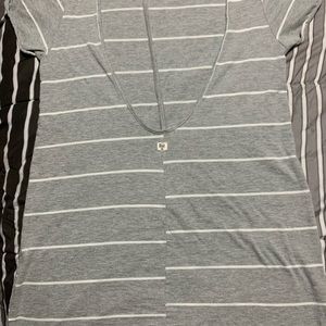 Lightly warn grey and white striped shirt. This shirt has a open back.